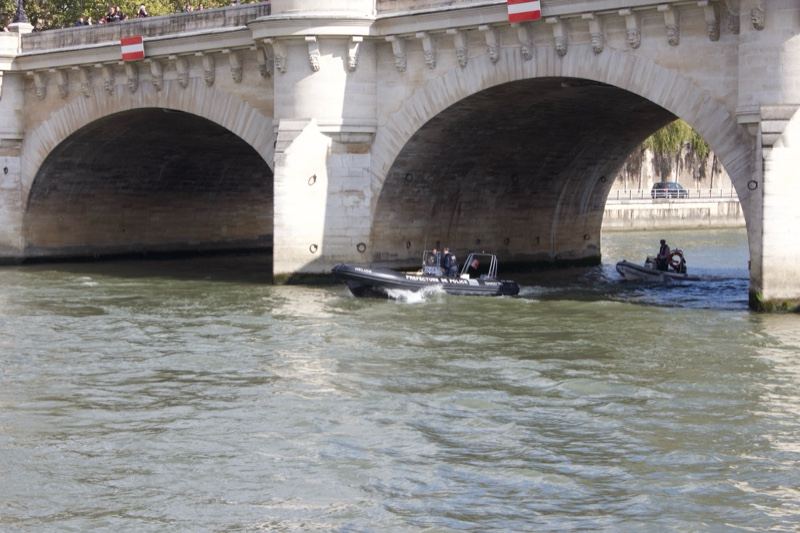Stone Bridge Over River With Boats