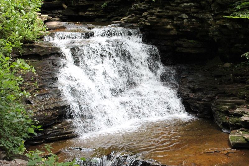 Small Cascade Over Rocky Cliff
