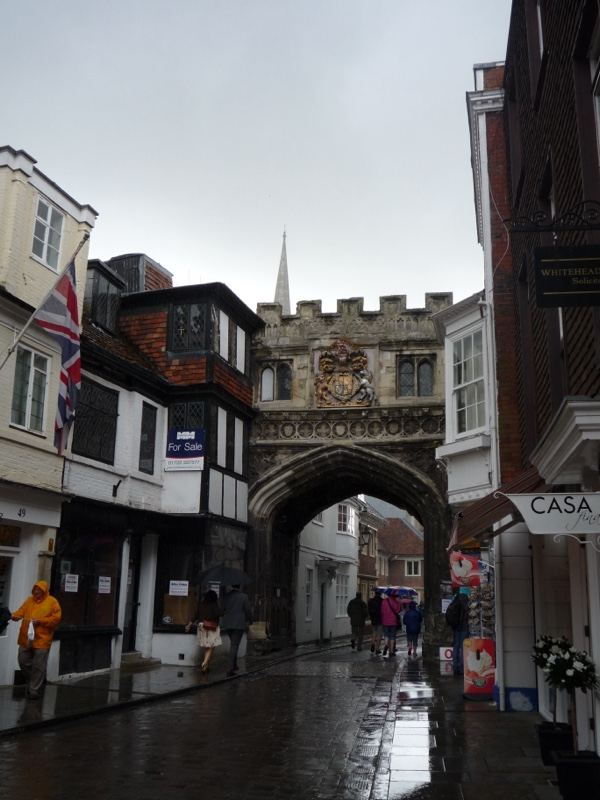Rainy Street Through Historic Archway
