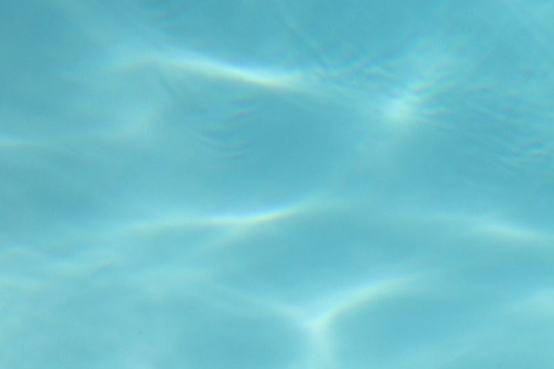 Sunlit Turquoise Pool Water Ripples