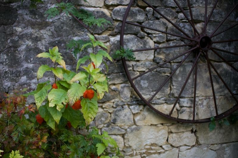 Wagon Wheel Against Stone Wall