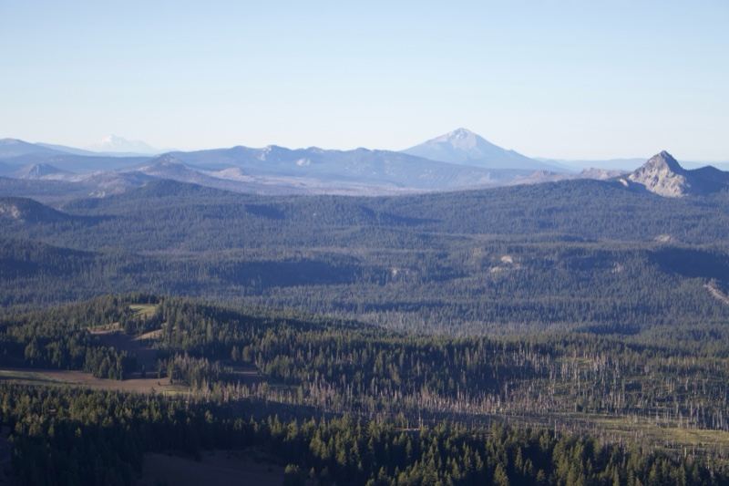 Distant Peaks Over Forested Hills