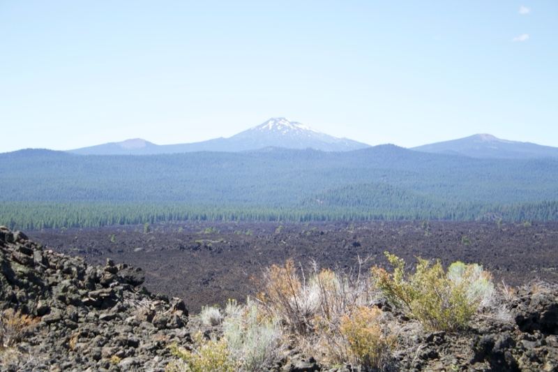 Snow-capped mountain over lava field