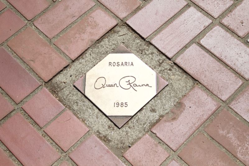 Rosaria plaque in brick pavement