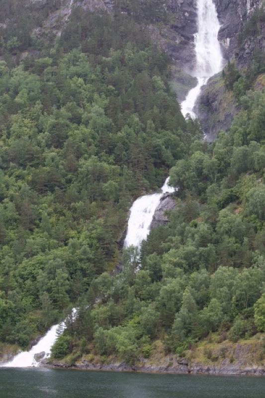 Waterfall Cascading Down Forested Cliff