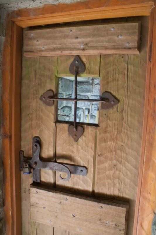 Rustic wooden door with iron hardware