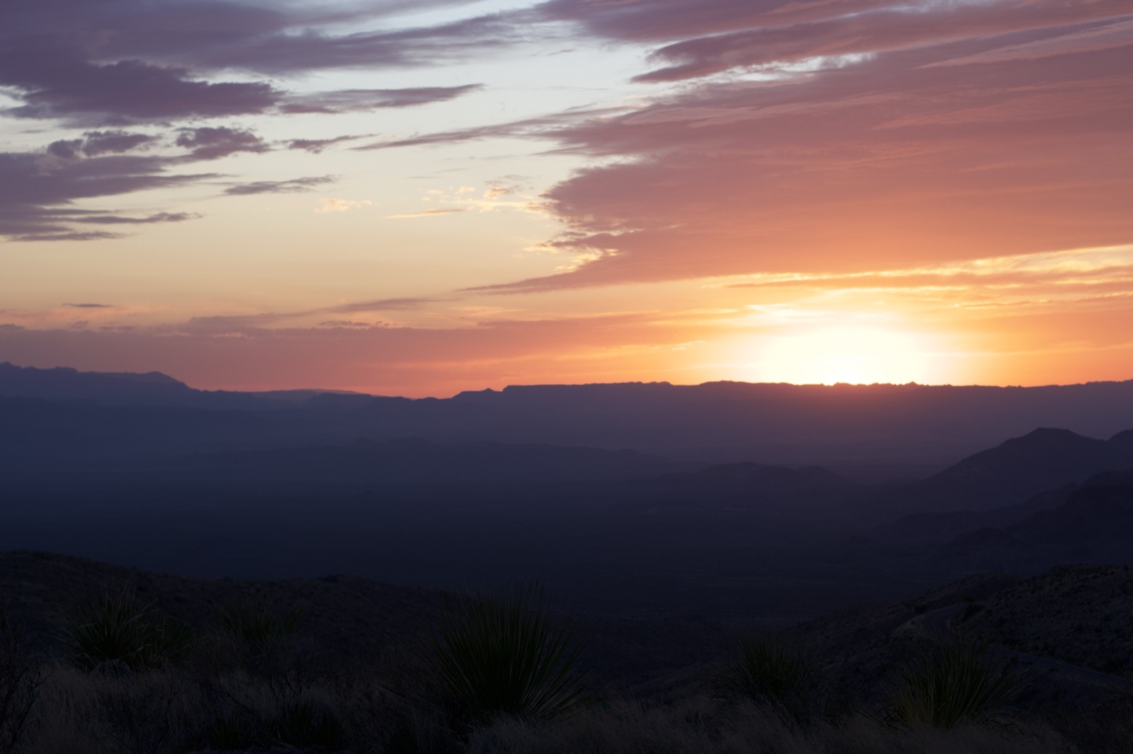 Desert Sunset Over Layered Mountains