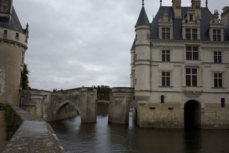 Chateau Over Moat Under Overcast Sky