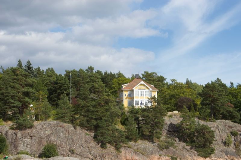 Yellow House on Rocky Cliff