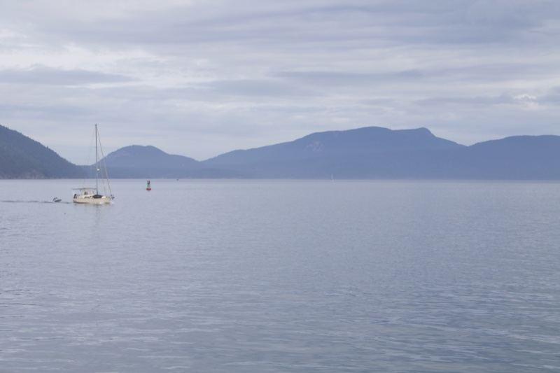 Sailboat on Calm Lake with Mountains