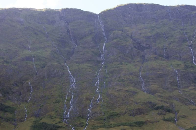 Mountain Slope With Cascading Waterfalls