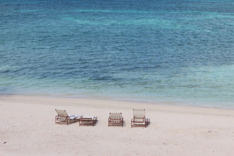 Empty Beach Chairs by Turquoise Sea