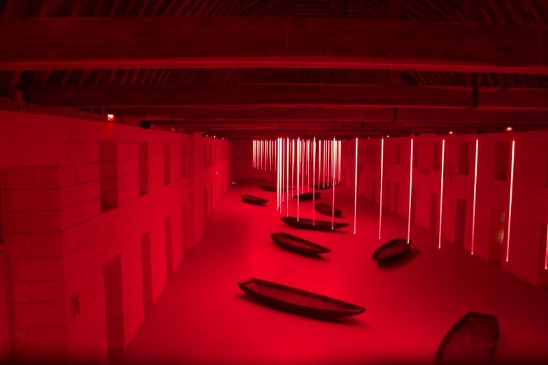 Red Lit Boats in Hallway Installation