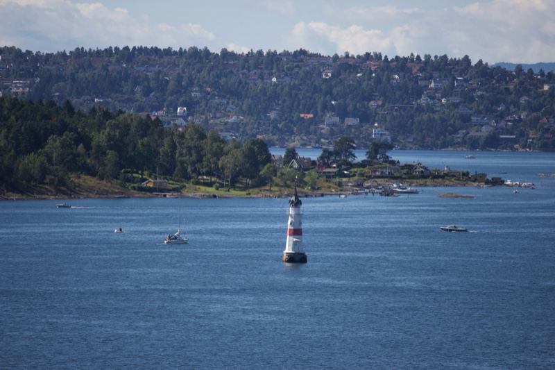 Lighthouse on Blue Water with Hills