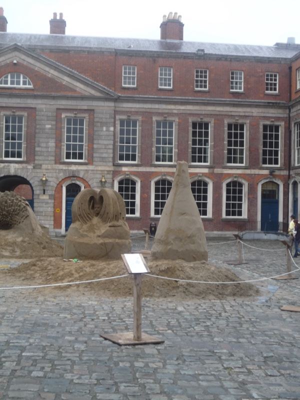 Sand sculptures in courtyard before historic building