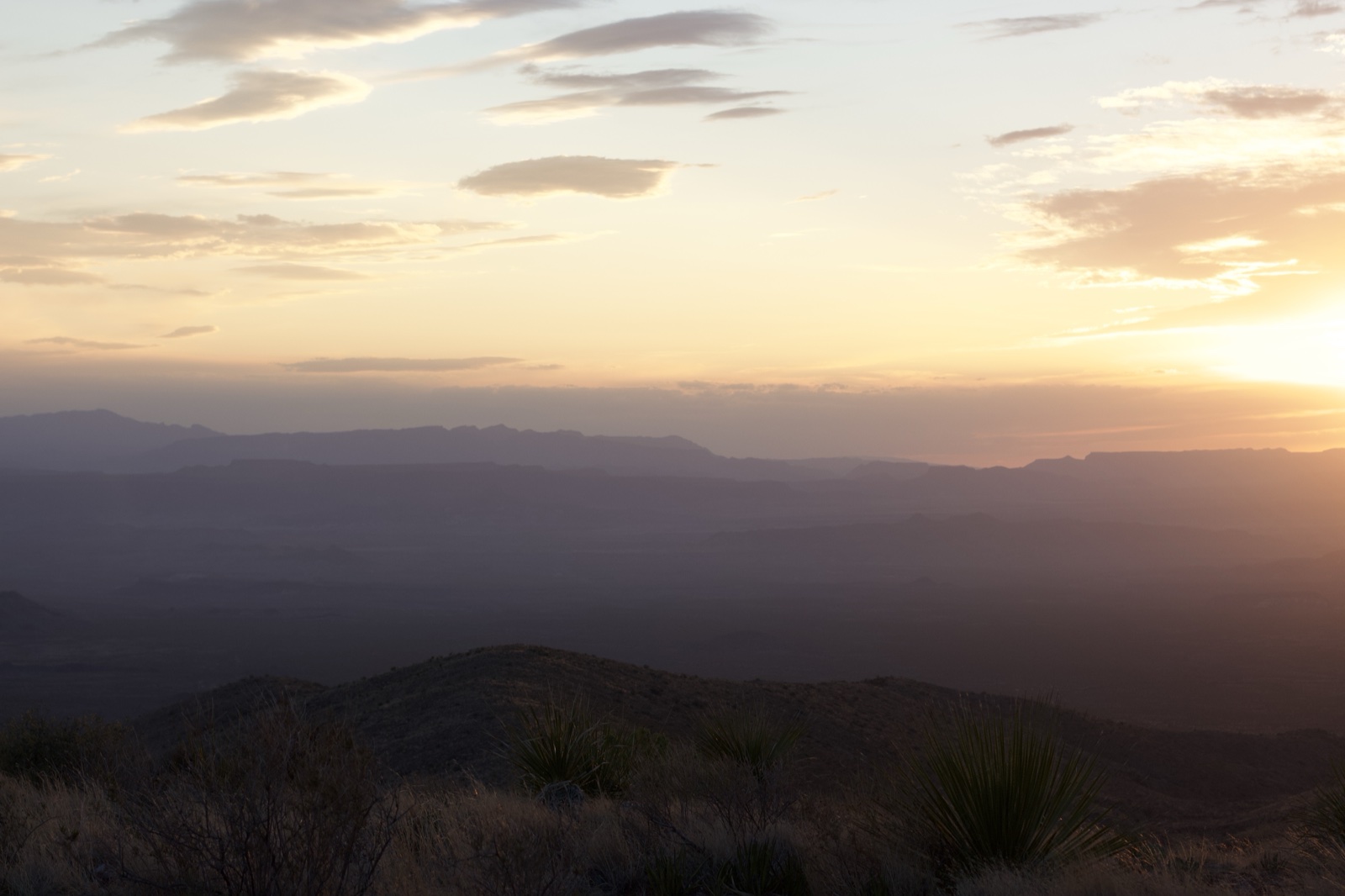 Desert Sunset Over Layered Mountains