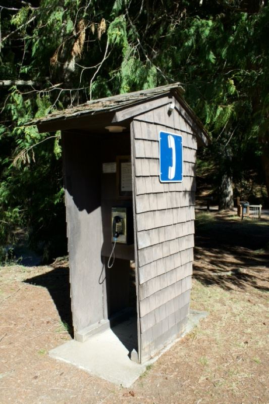 Wooden outdoor restroom in forest