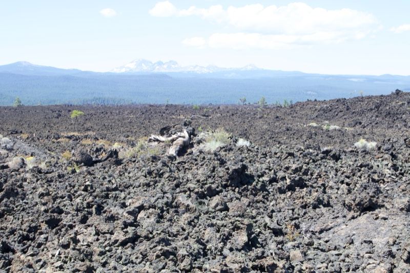 Volcanic Lava Field With Distant Mountains