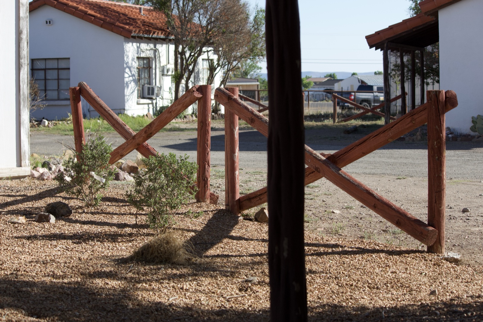 Wooden X Fence in Gravel Yard