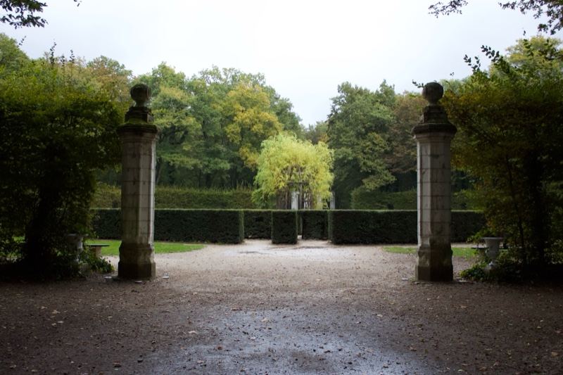 Formal Garden Entrance With Stone Pillars