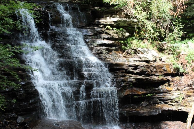 Tiered Waterfall Cascading Over Rocky Cliff
