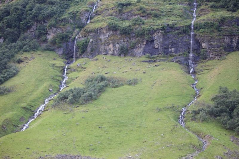 Twin Waterfalls on Grassy Mountain Slope