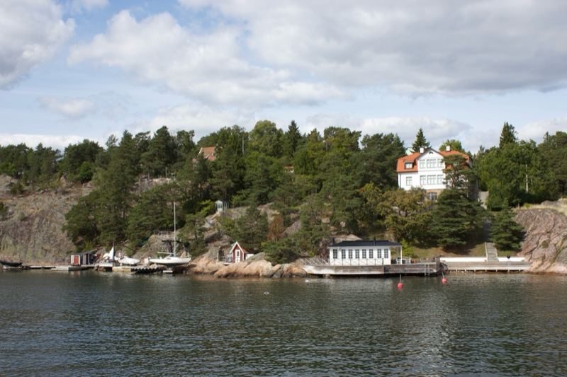 Coastal waterfront with houses and forest