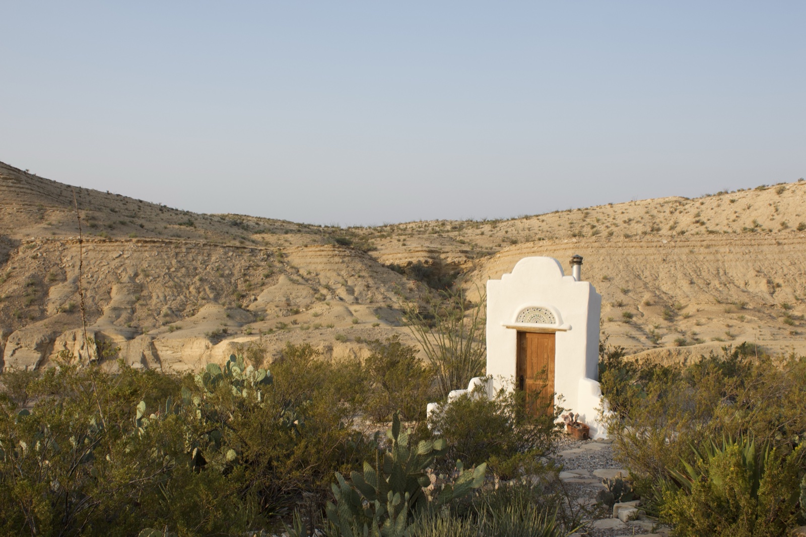 White adobe chapel in desert landscape