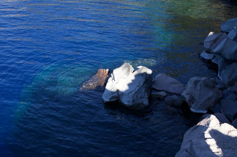 Rocky Shoreline Over Deep Blue Lake