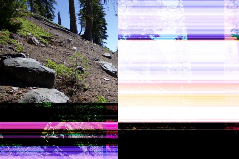 Glitched hillside with rocks and trees