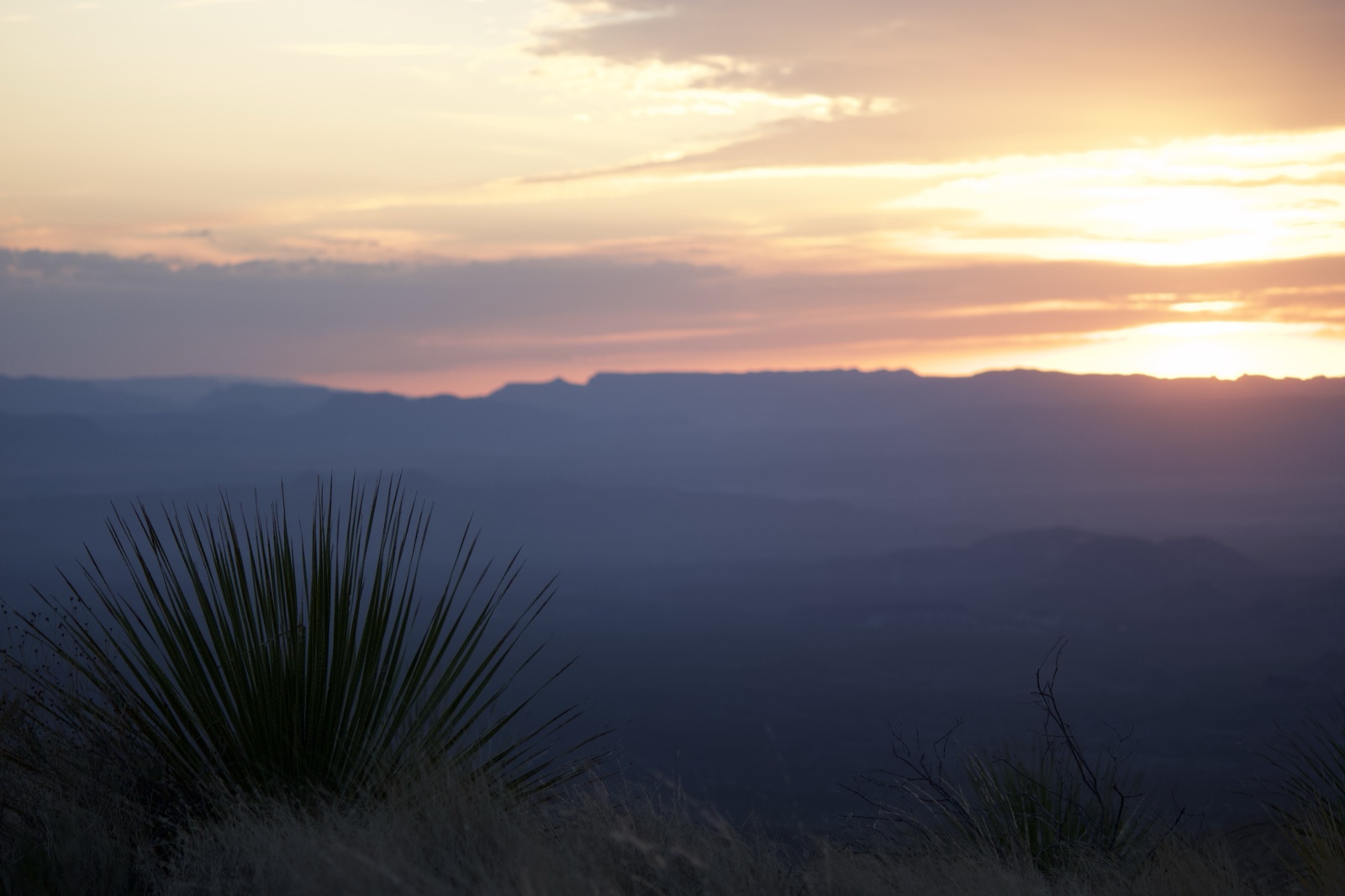Desert Sunset Over Distant Mountains