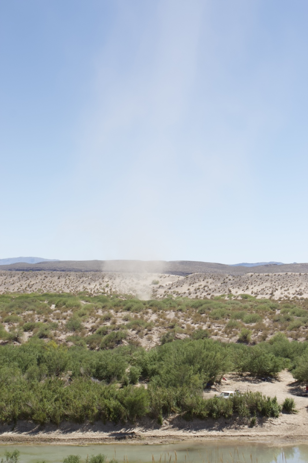 Dust Devil Over Desert Riverbank