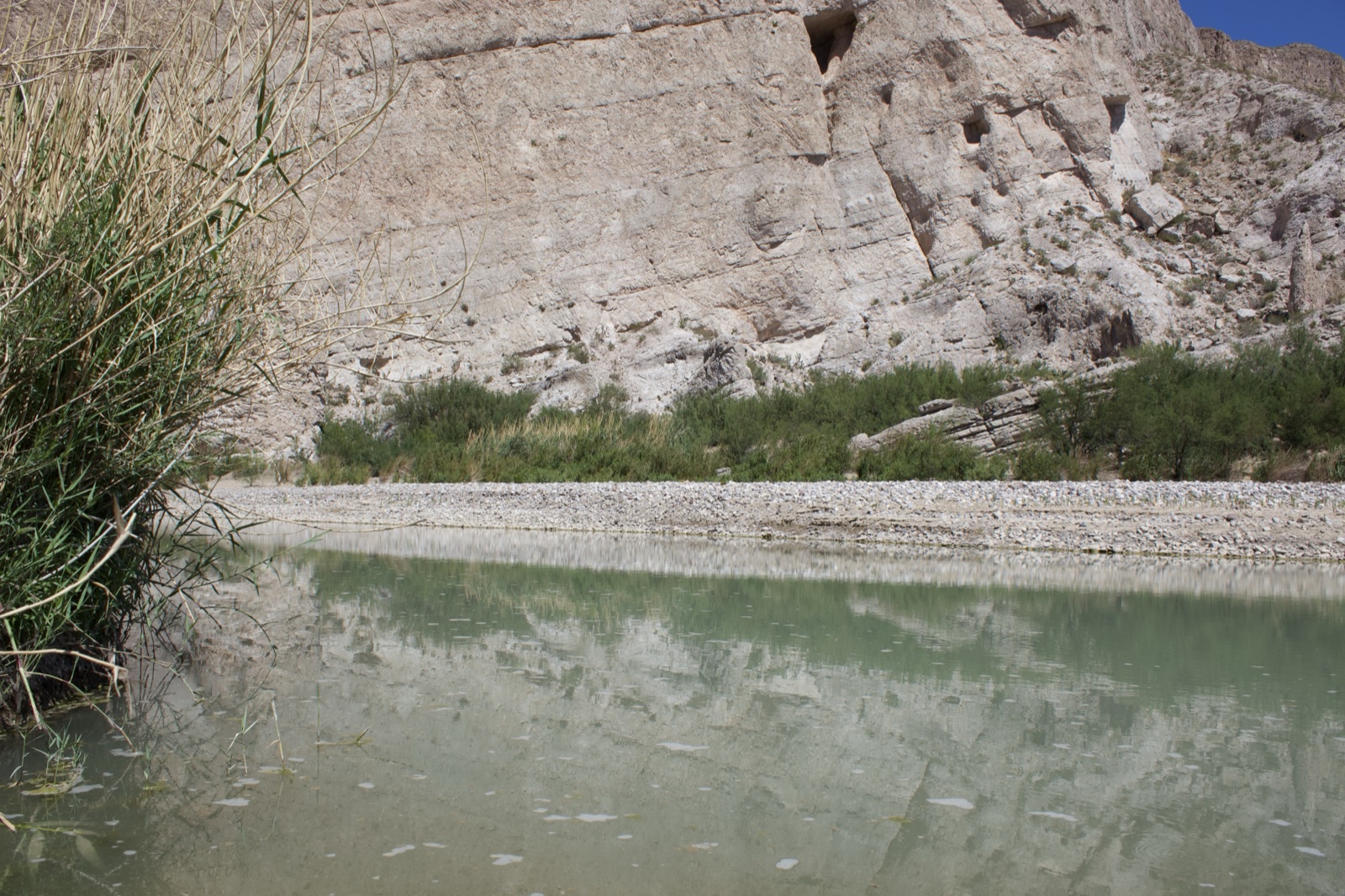 River Reflecting Limestone Canyon Wall
