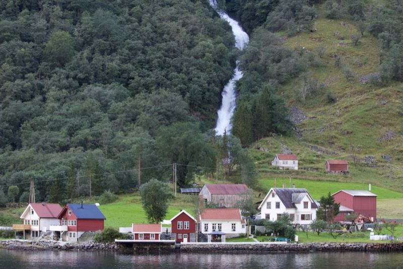 Waterfall Over Fjord Village Houses