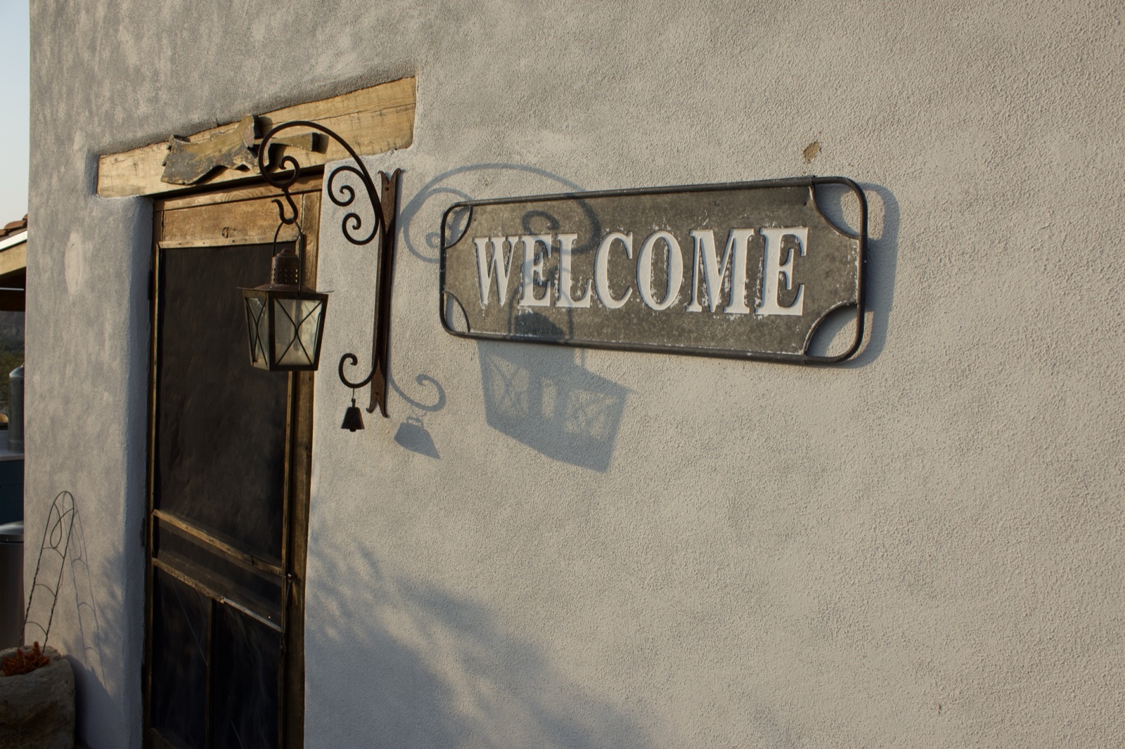Welcome Sign on Stucco Wall