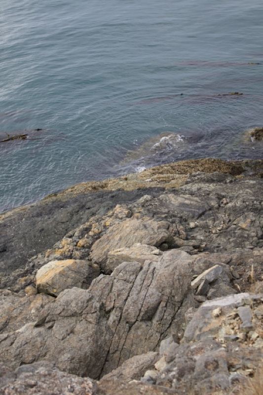Rocky Coastline Meeting Calm Sea