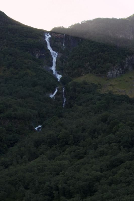 Mountain Waterfall Cascading Down Forest Slope
