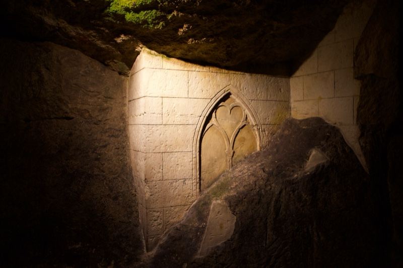 Gothic window in underground stone chamber