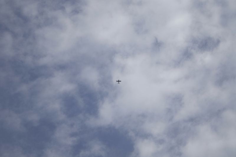 Small aircraft flying in cloudy sky