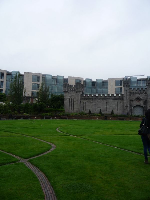 Courtyard Lawn with Castle Wall and Modern Building