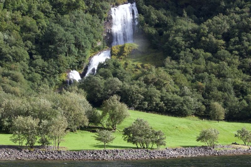 Waterfall Cascading Into Green Valley