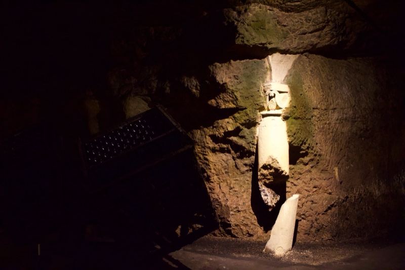 Illuminated Statue in Dark Cave