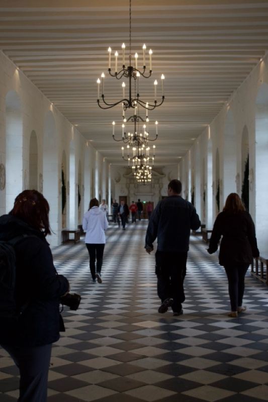 Grand Hallway with Chandeliers and Checkered Floor