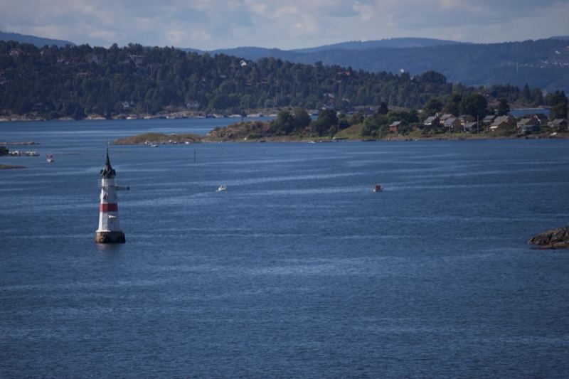 Lighthouse on Blue Water with Hills