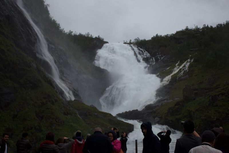 Tourists Watching Powerful Mountain Waterfall