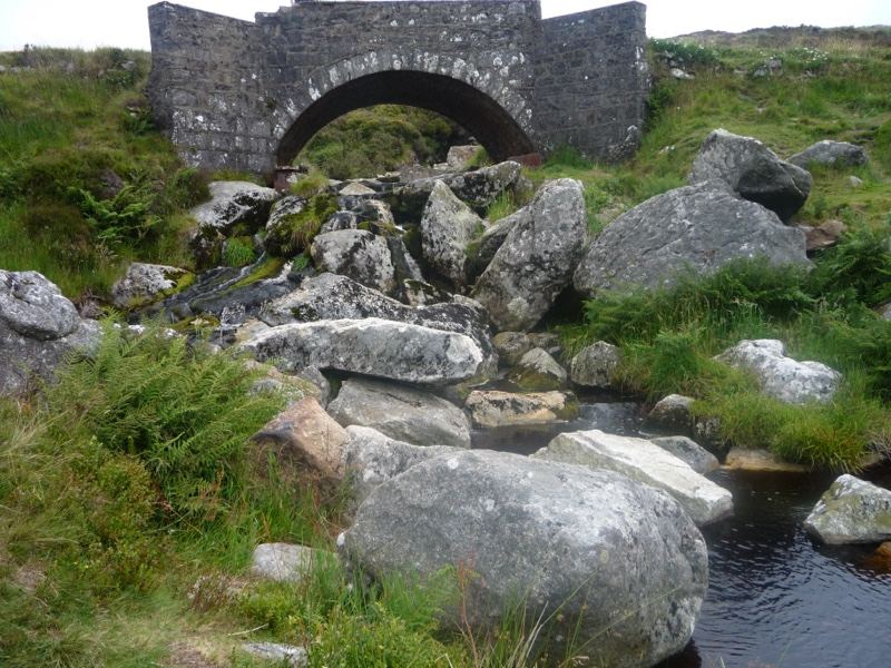 Stone arch bridge over rocky stream