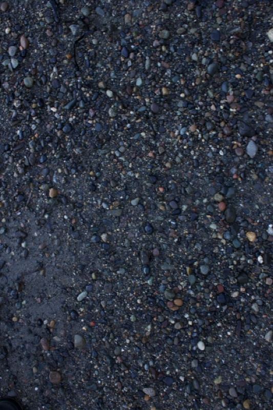 Wet gravel road surface texture