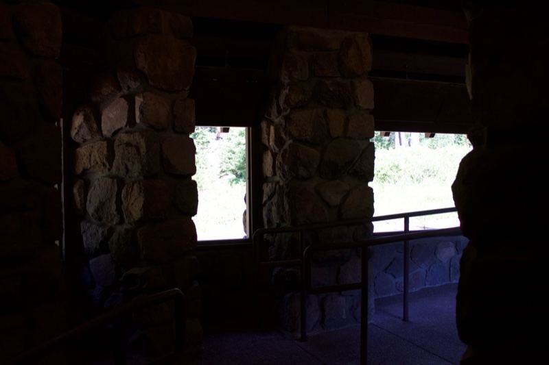 Stone lodge interior with forest view