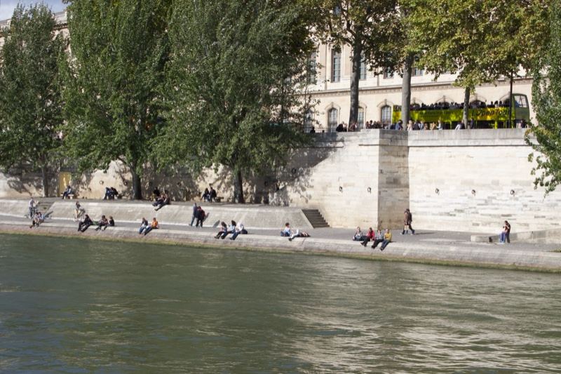 Paris Riverbank with People Relaxing