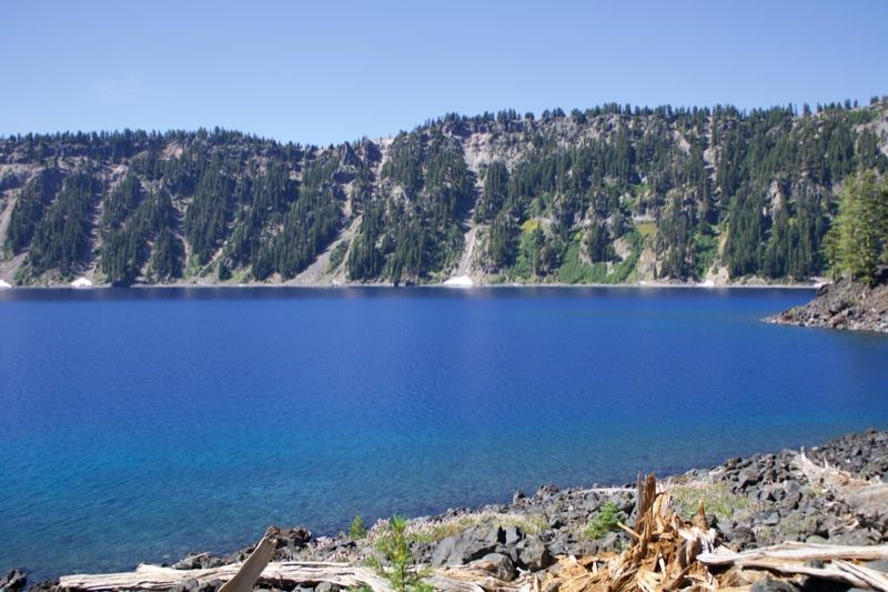 Deep Blue Crater Lake with Forested Cliffs
